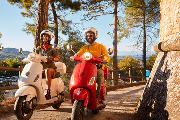 Wall Mural - Happy man and girl  riding a scooter and having fun.