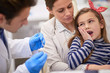 Toddler girl refusing to cooperate with a dentist