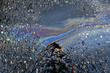 Iridescent oil sheen abstract. Oil stains are mobilized after rainstorm and form streaks on pavement 
