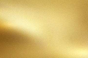 Gold foil metal wall with glowing shiny light, abstract texture background