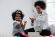 © Mongkolchon - african american mother and girl child playing toy together