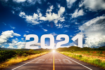 Wall Mural - The word 2021 behind the mountain of empty asphalt road at golden sunset and beautiful blue sky. Concept for vision year 2021. 