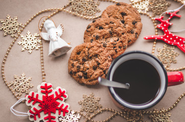 Red coffee mug on a brown background with red and white objects