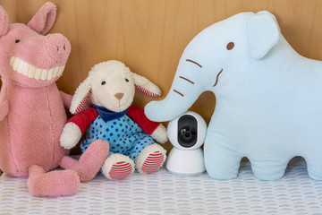 IP camera monitoring in a baby crib with children toys