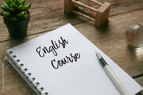 Plant,sand clock,glass globe,pen and notebook written with English Course on wooden background Canvas Print