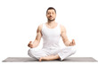 © Ljupco Smokovski - Young man meditating on a yoga mat