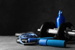 © New Africa - Gym equipment and accessories on stone floor against dark background