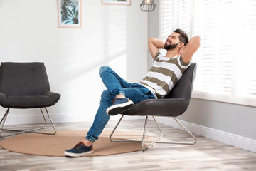 Wall Mural - Young man relaxing at home. Peaceful rest