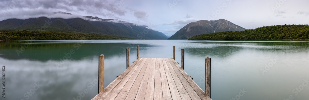 Landscape photo of a jetty on Lake Rotoiti, New Zealand. This jetty is within the  Nelson Lakes National Park and is one of the most Instagrammed locations in New Zealand - obrazy, fototapety, plakaty 