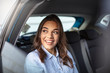 © Dragana Gordic - Businesswoman in car on the way to her workplace. Beautiful girl in the backseat. Beautiful businesswoman is sitting on back seat of the car. She is looking through the window dreamingly and smiling.
