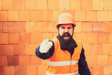 Wall Mural - Labor Day. Builder screams and shows finger forward. Bearded man worker.