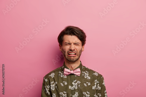 Fotografía Distressed gloomy man expresses negative emotions, wears fashionable shirt with