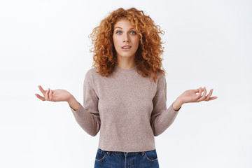 Careless, indifferent arrogant redhead woman with curly hair, wear blouse, shrugging indecisive, spread arms sideways, look confused and uncertain, have doubts, dont know, cant help, white background