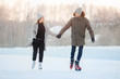 © Parilov - Ice skating lover couple having fun on snow winter holidays