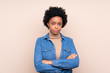 © luismolinero - African american woman over isolated background keeping arms crossed