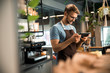© Yakobchuk Olena - Happy young barista looking at tablet screen in cafe