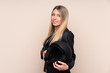 © luismolinero - Young blonde woman with a motorcycle helmet over isolated background laughing