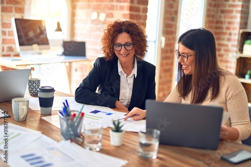 Two beautiful businesswomen smiling happy and confident Poster Mural XXL
