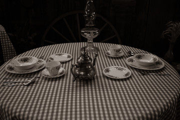 A horizontal photo of a setting for two in a dinning room.