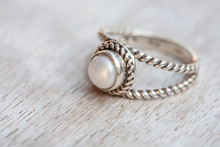 Silver Ring On Neutral Bright Wooden Background
