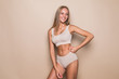 © F8  \ Suport Ukraine - Young woman in underwear on beige background. Fitness, diet, skin and body care