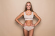 © F8  \ Suport Ukraine - Young woman in underwear on beige background. Fitness, diet, skin and body care