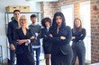 © Krakenimages.com - Group of business workers smiling happy and confident. Posing together with smile on face looking at the camera, young beautiful woman with crossed arms at the office