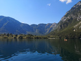 Fototapeta Niebo - Beautiful view of the crystal clear Bohinj lake from the water with the mountains in the background