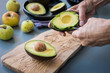 peeling a avocado by woman's hands 