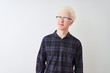 © Krakenimages.com - Young albino blond man wearing casual shirt and glasses over isolated white background smiling looking to the side and staring away thinking.