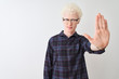 © Krakenimages.com - Young albino blond man wearing casual shirt and glasses over isolated white background doing stop sing with palm of the hand. Warning expression with negative and serious gesture on the face.