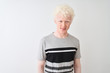 © Krakenimages.com - Young albino blond man wearing casual t-shirt standing over isolated white background with a happy and cool smile on face. Lucky person.
