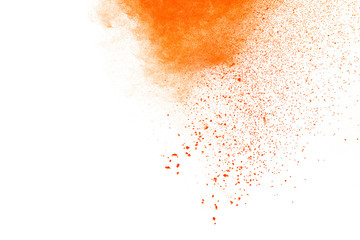 Wall Mural - Abstract orange powder explosion. Closeup of orange dust particle splash isolated on white background.