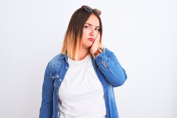 Sticker - Beautiful woman wearing denim shirt standing over isolated white background thinking looking tired and bored with depression problems with crossed arms.