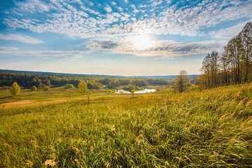 Wall Mural - beautiful panoramic view from above of the river valley and meadows in autumn on a sunny day.