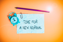 Conceptual Hand Writing Showing Time For A New Normal. Concept Meaning Make A Big Dramatic Change Replace The Expected Metal Alarm Clock Ccrushed Sheet Pencil Colored Background