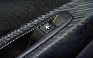 Car interior with closeup of window switch button