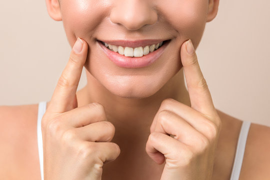 lip protection. closeup of a young woman beautiful smile, healthy lips and white teeth in high resolution