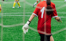 Unrecognizable Female Soccer Players Playing A Game On The Soccer Field.