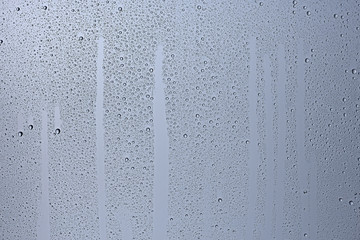 gray wet background / raindrops to overlay on the window, weather, background drops of water rain on the glass transparent