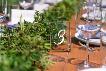 Preparing for an open-air party. Decorated with fresh flowers served tables. Table number. Decoration Details