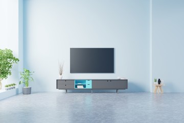 TV on the cabinet in modern living room on blue wall background.