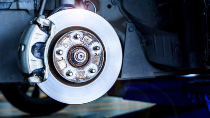 Closeup car disk brake maintenance service in car garage and copy spcae