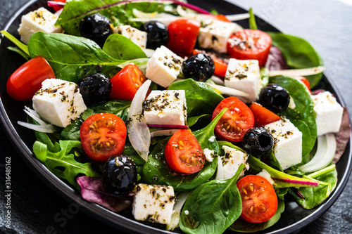 Cuadros en Lienzo Fresh greek salad - feta cheese, tomato, lettuce, black olives and onion