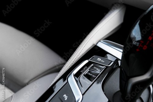 Cuadros en Lienzo Track control buttons near automatic gear stick in a white leather interior of a modern car