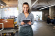 Close up portrait of a young business woman using digital tablet.