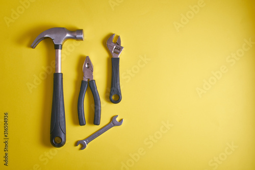 Fotomural A set of tools, a hammer, pliers, wrenches, on a yellow background