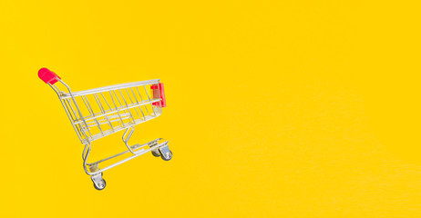 Sticker - supermarket grocery cart on a yellow