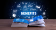 BENEFITS inscription coming out from an open book, business concept