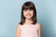 © fizkes - Little pretty smiling girl head shot studio portrait.